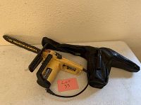 Yellow McCulloch Electramac EM14E electric chainsaw with 14-inch bar and partial view of second chainsaw with black protective cover.