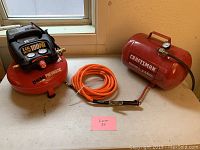 Overview showing Central Pneumatic air compressor, Craftsman air tank, and orange air hose