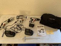 Full view of Shopforce cordless combo tool set with drill, reciprocating saw, charger, batteries, manual, and carry bag on white table.