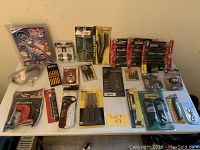 Full spread of packaged tools on table including Craftsman T-handle sets, screwdrivers, sockets, and other hardware accessories.