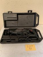 Reciprocating saw in open plastic carrying case with cord coiled inside case.