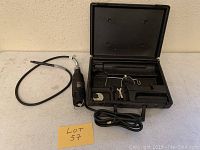 Full lot showing flex shaft tool, power cord, and open black plastic carrying case with accessories inside.