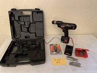 Overview of the Craftsman cordless drill, battery, charger, drill bit sets, and plastic carrying case.