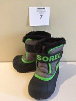 Front-left angle view of black, gray, and green toddlers winter boots with fur lining and Velcro strap with SOREL branding