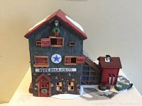 Porcelain Blue Star Ice Co. building with blue star logo, includes snow on roof and red accents, with smaller attached building and accessories