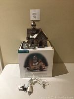 Department 56 Laurel Hill Church model placed on its box with attached light cord.