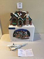 Tudor House model displayed on its box with foam insert, light cord, and information card.