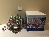 Front and side view of Department 56 Kringle's Korner holiday village building with accessories and original box