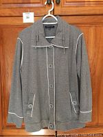 Front view of grey plus size 2X Jones New York Signature Woman jacket with white piping and button details