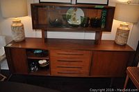 Front view of full cabinet ensemble with lamps and decorative contents on top and inside