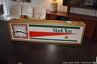 Full view of rectangular Mark Ten advertising clock showing clock face on the left and logo on the right with red and green colors.
