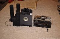 Overview showing subwoofer, five satellite speakers, AV receiver, headphones and remote control.