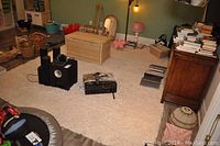 Image showing entire off white wool shag rug on floor surrounded by furniture and electronics.
