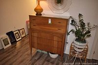 Front view showing overall design, drawer layout and tapered legs