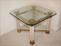 Full view of square brass accent table with fluted wooden legs and bevel-edged glass top.