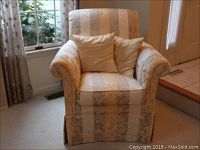 Front view of Ethan Allen ladies armchair with two pillows and arm protectors in cream and beige sateen fabric