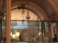 Photo of Lenox covered ginger jar displayed on glass shelf, showing white bone china with lid and price tag.
