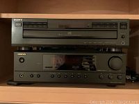 Sony 5-disc CD player and Onkyo TX-8011 stereo receiver stacked on shelf.