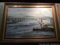 Full view of the framed oil on board painting of a European town showing river, buildings, and bridge.