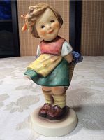 Front view of the Goebel 'Bashful' porcelain figurine showing the girl's attire and expression.