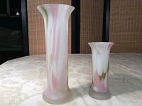 Two Birks glass vases on a cream patterned tablecloth with a natural woven backdrop, showing taller and shorter vases together