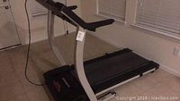 Side view of Pro-Form 735CS treadmill showing running belt, handrails, and control panel.