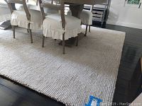 Full view of rug under dining table showing overall size and placement