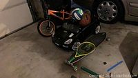 Overview showing Mongoose bicycle, ride-on car, sports balls, tennis racket and skateboard