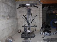 Full front view of Bowflex Ultimate 2 home gym machine installed in basement