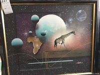 Full view of abstract giraffe art showing outer space with planets, Earth, and giraffe silhouette, framed in black with gold trim.
