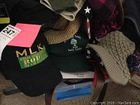 Hats including baseball caps with MLK and North Carolina designs along with knit hats.
