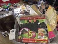 Various new hair pieces in original packaging, stacked on a table showing brand labels and styles.