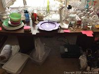 Dining table shown with various household items on top, items are not included in the sale.