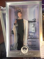 Audrey Hepburn doll in black gown with shawl and accessories inside the original box labeled 'Classic Edition' and 'Breakfast at Tiffany's'