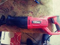 Hyper Tough Black and Red Reciprocating Saw with Power Cord on a Carpeted Surface