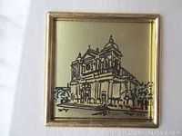 Close-up image showing the detailed lithograph of Serra San Bruno Commune Building on a 23 karat gold sheet background.