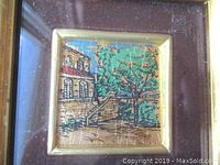 Close-up of the 23 karat gold leaf lithograph showing the building, stairs, and green tree with golden background.
