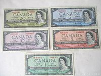 Set of five Canadian banknotes from 1954 featuring Queen Elizabeth II in denominations $1, $2, $5, $10, $20.