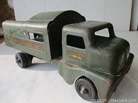 Full side view of vintage Structo Toys Telephone Co. truck showing cab and covered cargo section with six wheels.