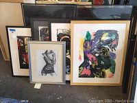 All five framed artworks grouped on floor