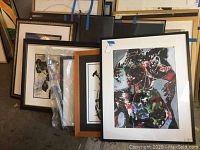 View of all five framed paintings in a stacked arrangement, showing various frames and artworks.