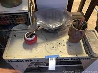 Full view of potter's wheel unit with tools and holders on top