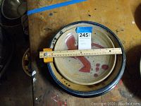 Three plates stacked showing red design top plate over dark-rimmed plate