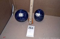 Both vases side by side with ruler and lot tag for scale