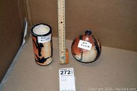 Both vases shown side by side with ruler indicating heights and a lot tag visible