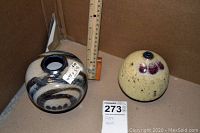 Both vases side by side with ruler for scale