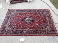 Full view of rug laid flat on pavement showing overall pattern and size