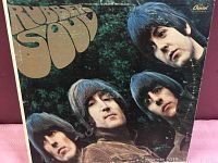 Front cover of The Beatles Rubber Soul album showing the band members and Rubber Soul title with visible surface wear.