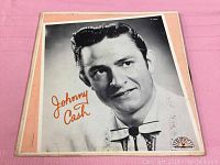 Front album cover with black and white photo of Johnny Cash, Sun Records logo on bottom right corner, some edge wear visible.