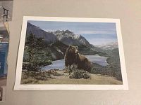 Full view of the signed numbered print depicting a bear looking over a mountainous lake landscape